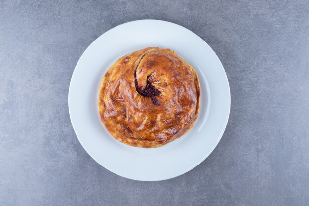 Homemade pie on a plate , on the marble.