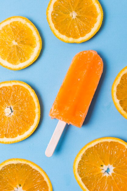 Homemade popsicle ice cream and slices of orange