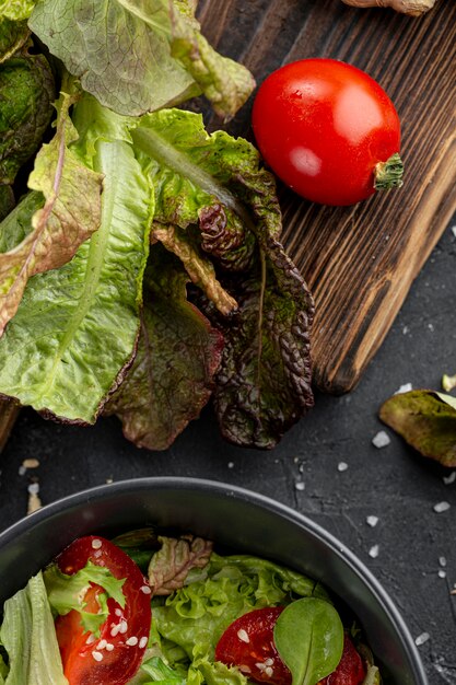 Homemade salad ingredients on dark background