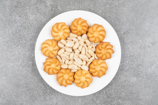 Homemade sweet biscuits and cashew on white plate