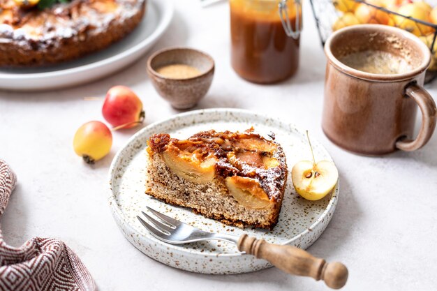 Homemade tarte tatin pie with apples and nuts on a beige background French apple pie selective focus