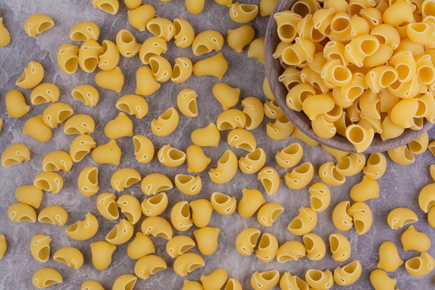 Homemade uncooked pastas isolated on the marble surface