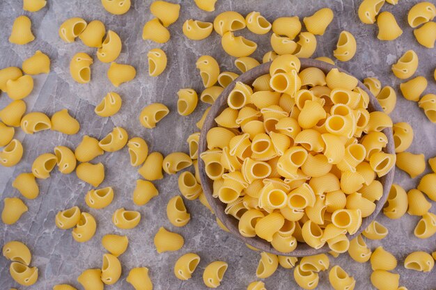 Homemade uncooked pastas isolated on the marble surface