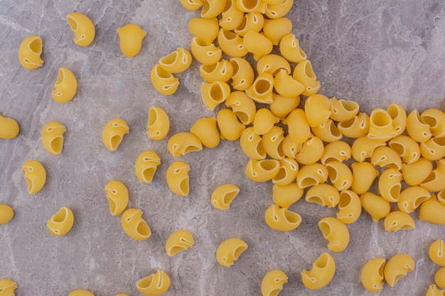 Homemade uncooked pastas isolated on the marble surface