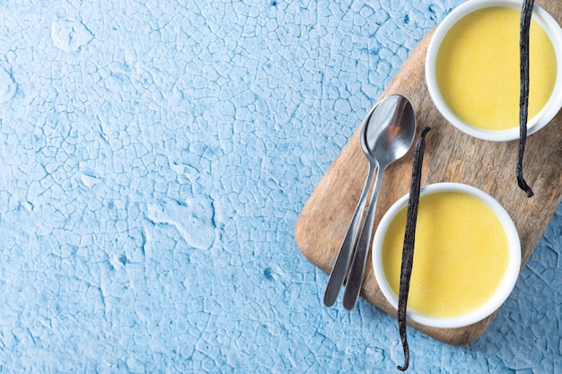 Free Photo homemade vanilla custard on blue background