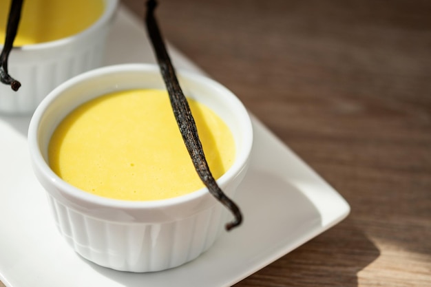 Homemade vanilla custard on wooden table