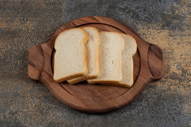 Free photo homemade white bread on wooden board.