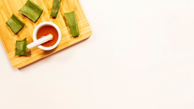 Honey and aloevera slice over wooden cutting board isolated on white background