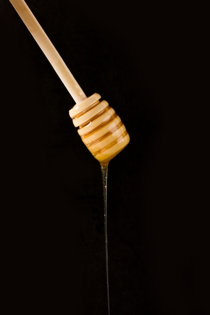 Free photo honey falling from spoon