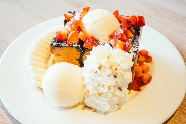 Honey toast with ice cream and strawberry and banana