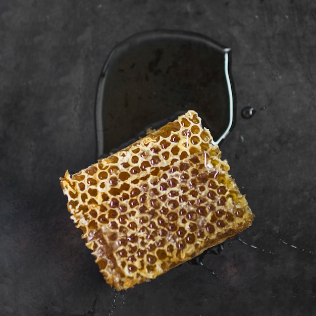 Free photo honeycomb piece on black textured background