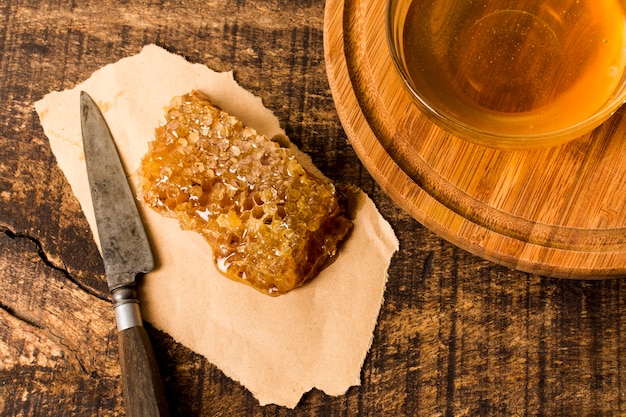 Free photo honeycomb with knife and tea