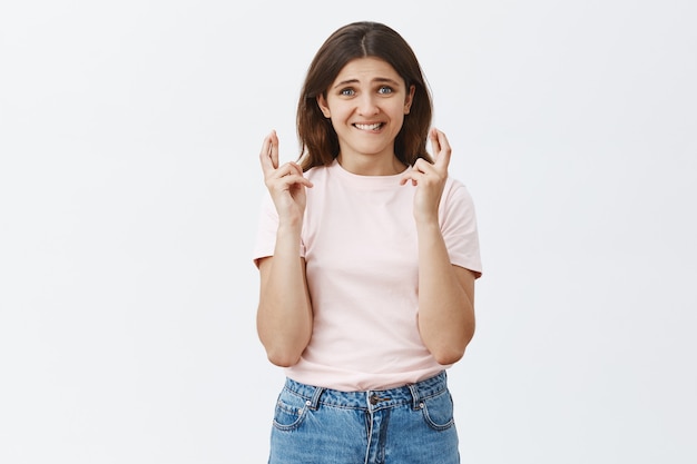 Hopeful worried young brunette posing