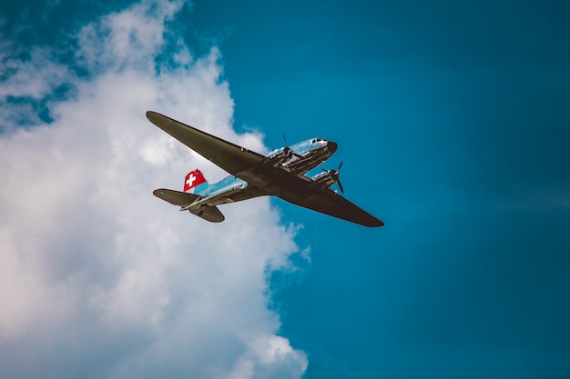 Free photo horizontal low angle shot of a silver airplane under the beautiful cloudy sky