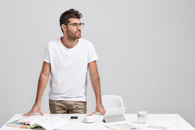 Horizontal portrait of bearded businessman wears casual clothes and glasses