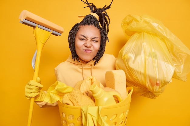 Free photo horizontal shot of busy housewife smirks face makes grimace