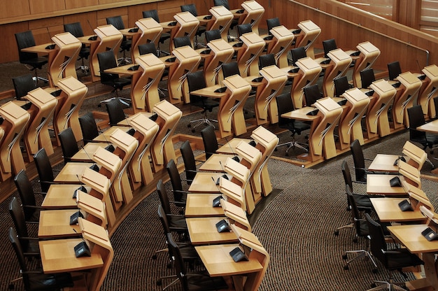 Horizontal shot of the desks inside of the Scottish parliament building