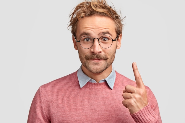 Free Photo horizontal shot of handsome satisfied hipster has moustache, dressed in elegant clothes