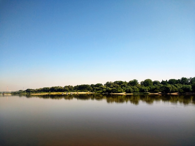 Horizontal shot of the lake and dense forests on its' shore in Warsaw, Poland