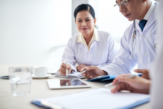 The hospital workers analyzing medical data at a meeting