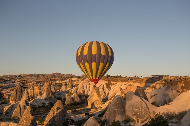 Free photo hot air balloons over the hills and the fields during sunset in cappadocia, turkey