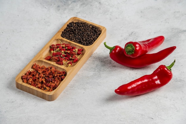 Free photo hot chili peppers and spices on marble background.