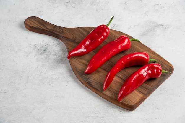 Hot chili peppers on wooden board.