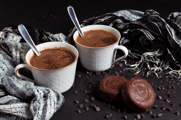 Hot chocolate in cups with biscuits