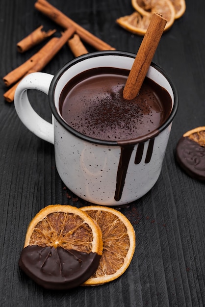 Free photo hot chocolate with cinnamon stick and dried orange slices