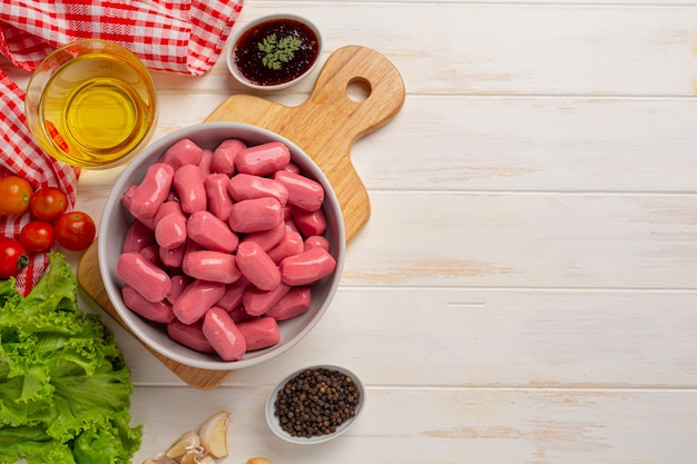 Hot dog or sausages on the white wooden surface.