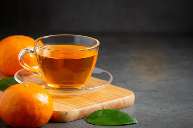 Hot orange tea and fresh orange on the table