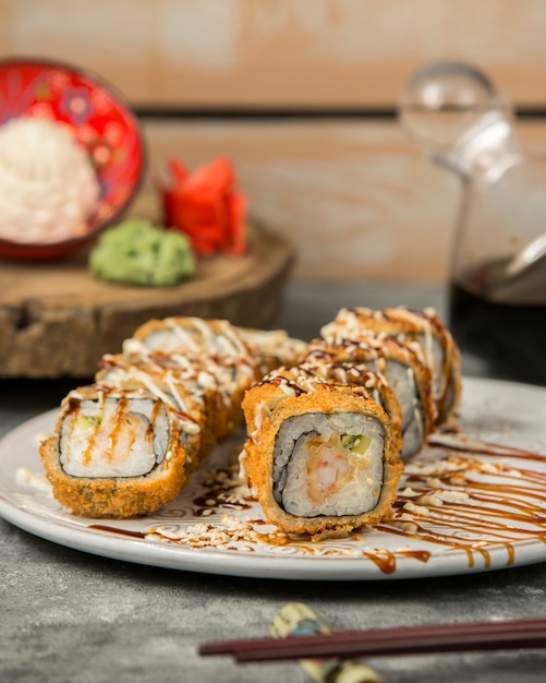 Free Photo hot sushi rolls with shrimp and cucumber garnished with sauce and sesame