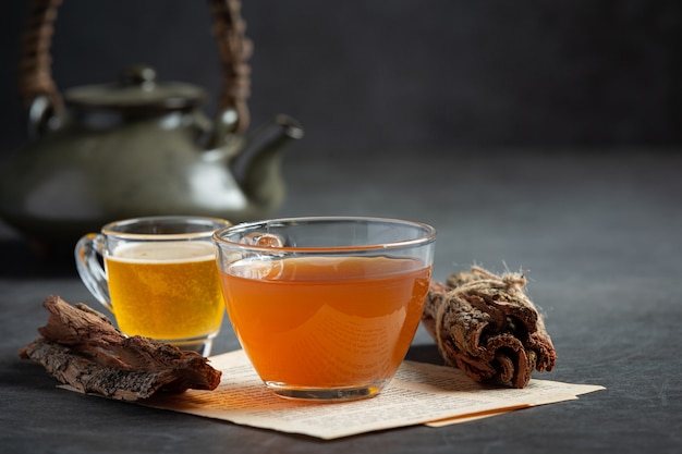 Hot tea and bark on table