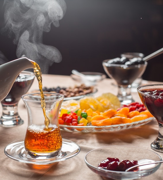 hot tea poured into armudu glass in traditional azerbaijani tea setup