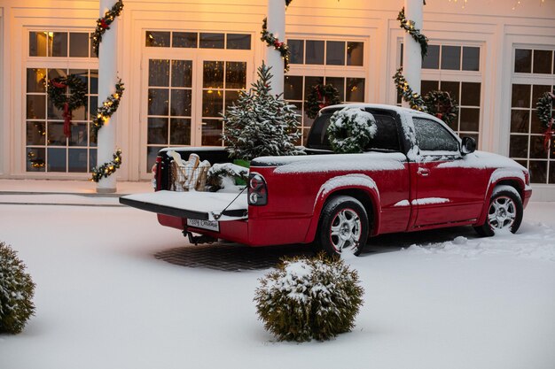 House decorated for Christmas with red car.