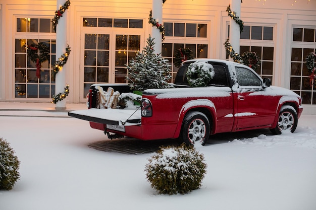 House decorated for Christmas with red car.