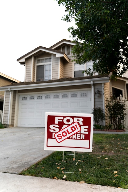 Free photo house with sold yard sign