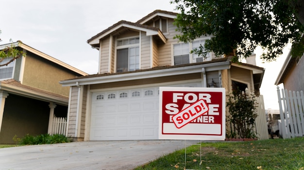 House with sold yard sign