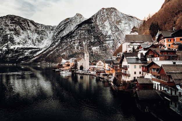 Houses near body of water and mountain