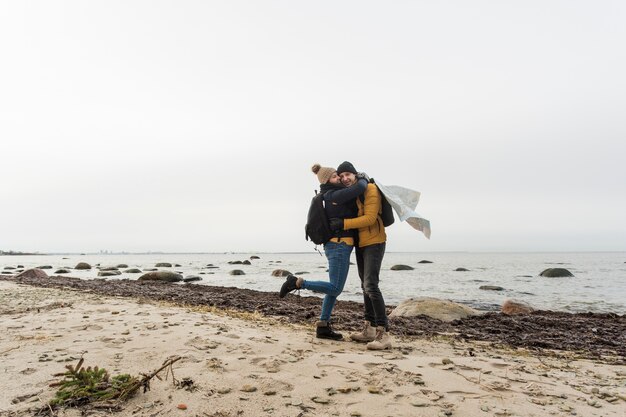 Hugging couple with map