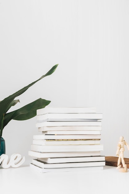 Free Photo human figure and plant near books