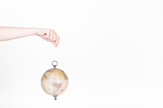 Free Photo human hand holding globe pendulum