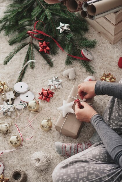 Human hand preparing gifts at Christmas