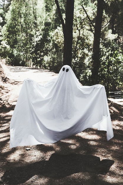 Free photo human in phantom clothes levitating above walkway in forest