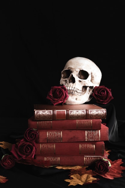 Human skull with roses on books