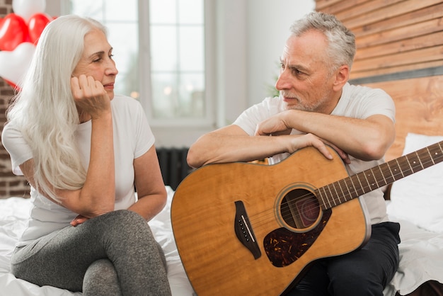 Husband singing at quitar for wife