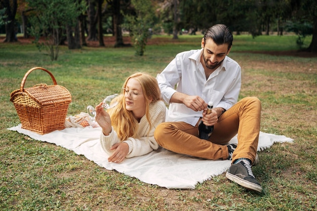 Husband and wife having a picnic together outdoors