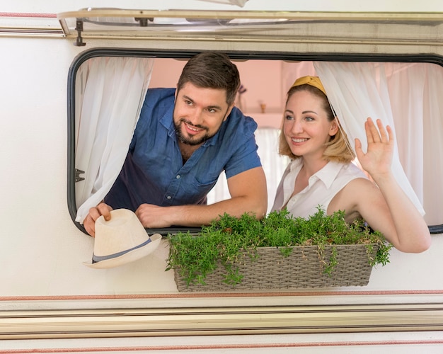 Husband and wife looking out of a caravan window