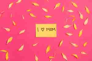 Free photo i love mom paper among floral petals