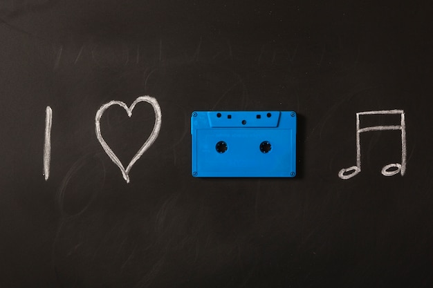 Free Photo i love music icons drawn with blue cassette on blackboard